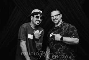 Candid black and white photo of Beau and John from Howe Eventful, captured mid-conversation at a recent event, showcasing their behind-the-scenes focus and teamwork. Photo by The Portraits Lounge.